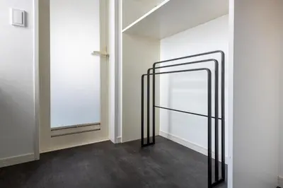a hallway with a mirror and white walls at NEXUS HOTEL Gotanda WEST in Tokyo
