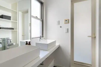 a white bathroom with a sink and a mirror at NEXUS HOTEL Gotanda WEST in Tokyo
