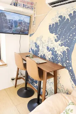 a table and chairs in a room with a mural at Monthly Stay Furnished Apartment \u6c60\u888b\u99c5\u5f92\u6b69 5\u5206 Mejiro Yasu Hotel in Tokyo