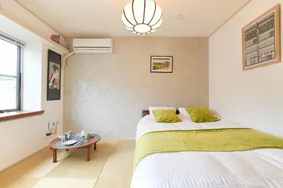 a bedroom with a bed and a table at Monthly Stay Furnished Apartment \u6c60\u888b\u99c5\u5f92\u6b69 5\u5206 Mejiro Yasu Hotel in Tokyo