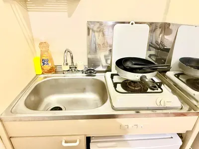 a kitchen with a sink and a pot on a stove at \u9ad8\u7530\u99ac\u5834 4\u4eba\u53efa2 in Tokyo