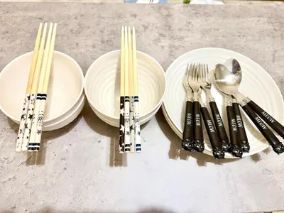 a table topped with white plates and forks and spoons at \u9ad8\u7530\u99ac\u5834 4\u4eba\u53efa2 in Tokyo