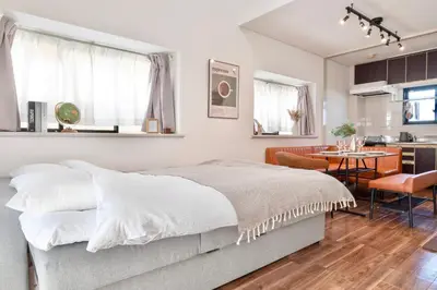 a bedroom with a bed and a dining room at \u30b6\u30eb\u30c4\u66f3\u821f in Tokyo