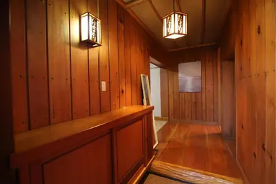 a hallway with wood paneled walls and two lights at Nakai House!! Tokyo Home near Shinjuku - Groups & Families in Tokyo