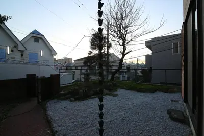 a tree in the middle of a yard with buildings at Nakai House!! Tokyo Home near Shinjuku - Groups & Families in Tokyo