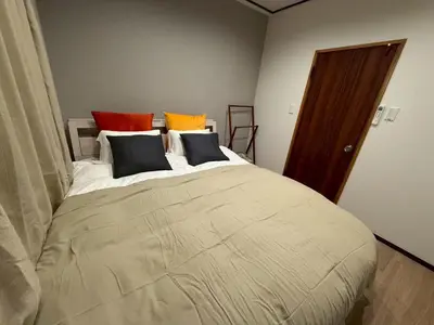 a bedroom with a large bed with colorful pillows at Nakai House!! Tokyo Home near Shinjuku - Groups & Families in Tokyo