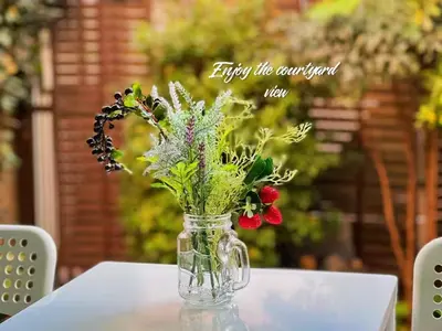 a vase filled with flowers sitting on a table at House near Shinjuku with parking & courtyard in Tokyo