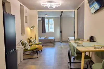 a living room with a table and a room with a bed at \u5bbf\u6816\u4e21\u56fd in Tokyo