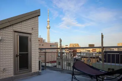 a balcony with a hammock and a view of a city at \u5bbf\u6816\u4e21\u56fd in Tokyo
