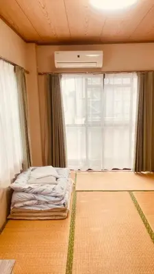 a bedroom with a bed in front of a window at Skytree Residence \u9326\u7cf8\u753a \u99c5\u304b\u3089600M\u5f92\u6b698\u5206 in Tokyo