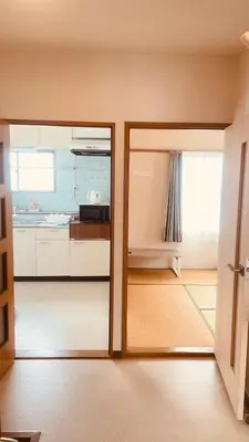 a kitchen with a door open to a kitchen with a counter at Skytree Residence \u9326\u7cf8\u753a \u99c5\u304b\u3089600M\u5f92\u6b698\u5206 in Tokyo