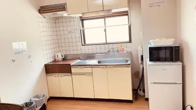 a small kitchen with a sink and a microwave at Skytree Residence \u9326\u7cf8\u753a \u99c5\u304b\u3089600M\u5f92\u6b698\u5206 in Tokyo