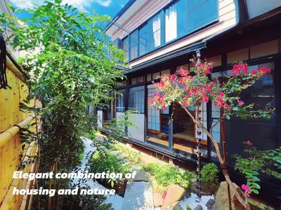 an external view of a house with plants and flowers at Charming Japanese Villa with Quiet, Private Garden in Tokyo