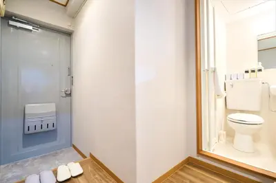 a bathroom with a toilet and a glass door at O-JR \u9ad8\u7530\u99ac\u5834 5mins walk Guest House! New open! Wi-fi! Shinjyuku Waseda area in Tokyo