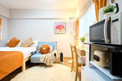a small bedroom with a bed and a tv at O-JR \u9ad8\u7530\u99ac\u5834 5mins walk Guest House! New open! Wi-fi! Shinjyuku Waseda area in Tokyo