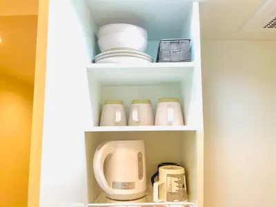 a white cupboard with dishes and appliances in it at Z5-Shinjuku center 4 mins to ST Max 3P-\u65b0\u5bbf\u6700\u4e2d\u5fc3 \u6771\u65b0\u5bbf\u99c54\u5206 \u76f4\u8fbe\u65b0\u5bbf \u6e0b\u8c37 \u8868\u53c2\u9053 \u6c60\u888b \u4e0a\u91ce \u4ee3\u4ee3\u6728 \u9280\u5ea7 \u539f\u5bbf in Tokyo