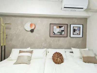 a bedroom with a white bed with pictures on the wall at G35\u65b0\u5bbf\u6700\u4e2d\u5fc3 \u6771\u65b0\u5bbf\u7ad95\u5206-Shinjuku center 5 mins to st, Max 4P \u65b0\u5bbf \u6d89\u8c37 \u8868\u53c2\u9053 \u6c60\u888b \u4e0a\u91ce \u4ee3\u4ee3\u6728 \u94f6\u5ea7 \u539f\u5bbf in Tokyo