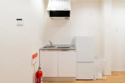 a kitchen with a sink and a refrigerator at \u745e\u306e\u5bbf\u6d45\u8349 in Tokyo