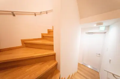 a staircase in a room with wood flooring at \u745e\u306e\u5bbf\u6d45\u8349 in Tokyo