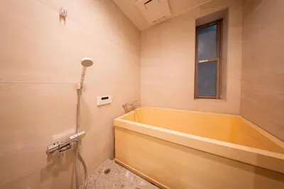 a bathroom with a tub and a window at \u745e\u306e\u5bbf\u6d45\u8349 in Tokyo