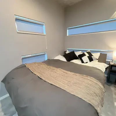 a bed in a bedroom with two windows at 103, Higashi-Yotsugi 3A, Entire house for rent, \u6771\u56db\u3064\u67283A in Tokyo