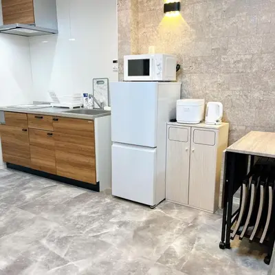 a kitchen with a white refrigerator and a microwave at 103, Higashi-Yotsugi 3A, Entire house for rent, \u6771\u56db\u3064\u67283A in Tokyo
