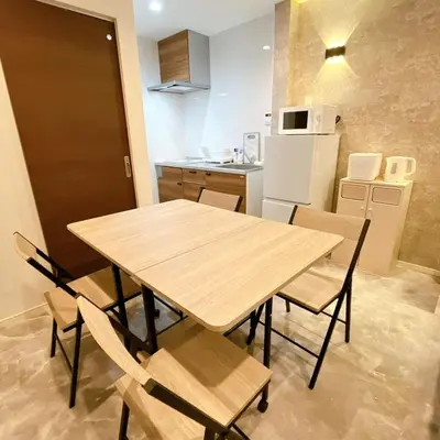 a kitchen with a wooden table and chairs in a room at 103, Higashi-Yotsugi 3A, Entire house for rent, \u6771\u56db\u3064\u67283A in Tokyo