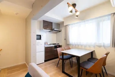 a small kitchen and dining room with a table and chairs at Uvas\u6c60\u888b in Tokyo
