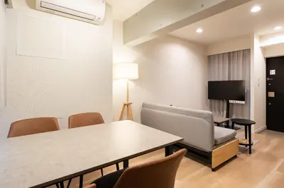 a room with a table and chairs and a tv at Uvas\u6c60\u888b in Tokyo