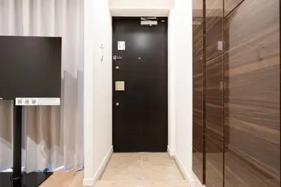 a hallway with a black door in a room at Uvas\u6c60\u888b in Tokyo