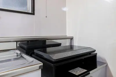 a kitchen with a stove top in a refrigerator at \u5165\u82392\u4e01\u76ee\u6238\u5efa\u3066 in Tokyo
