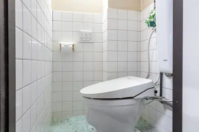 a white bathroom with a toilet in a room at \u5165\u82392\u4e01\u76ee\u6238\u5efa\u3066 in Tokyo