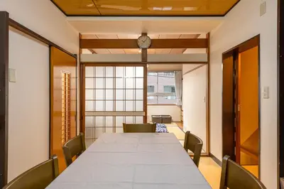 a long table in a room with a clock on the wall at \u5165\u82392\u4e01\u76ee\u6238\u5efa\u3066 in Tokyo