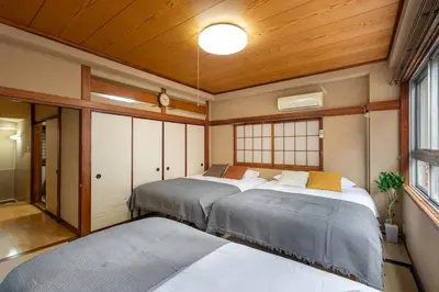 two beds in a room with wooden ceilings at \u5165\u82392\u4e01\u76ee\u6238\u5efa\u3066 in Tokyo