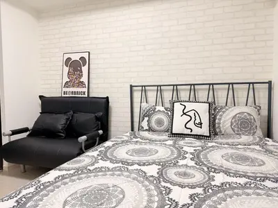 a bedroom with a bed and a chair at S6 Shibuya center-350m from Shibuya st ation in Tokyo