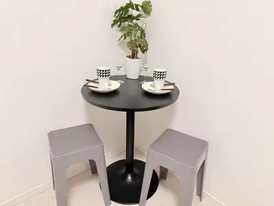 a black table with two stools and a table with two cups at S6 Shibuya center-350m from Shibuya st ation in Tokyo