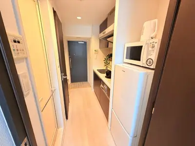 a small kitchen with a refrigerator and a microwave at S6 Shibuya center-350m from Shibuya st ation in Tokyo