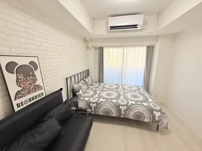 a bedroom with a bed and a couch at S6 Shibuya center-350m from Shibuya st ation in Tokyo