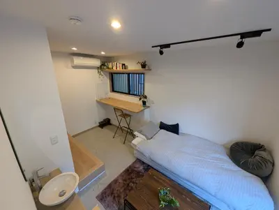 a small bedroom with a bed and a desk at Yahiro House in Tokyo