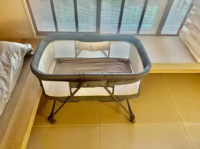 a crib in a room with a window at Hotel Matoma in Tokyo