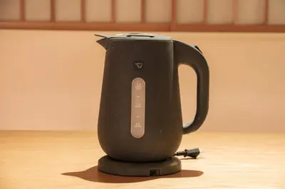 a black appliance sitting on a wooden table at Hotel Matoma in Tokyo