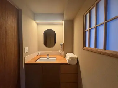 a bathroom with a sink and a mirror at Hotel Matoma in Tokyo