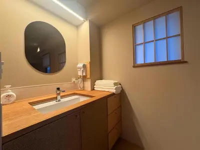a bathroom with a sink and a mirror at Hotel Matoma in Tokyo