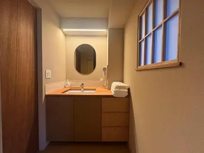 a bathroom with a sink and a mirror at Hotel Matoma in Tokyo