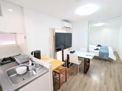 a kitchen with a sink and a table in a room at SEIRYU Bldg in Tokyo