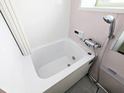 a white bath tub in a bathroom with a window at SEIRYU Bldg in Tokyo