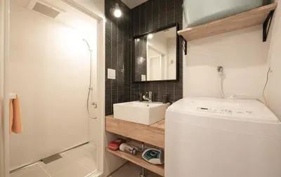 a bathroom with a white sink and a mirror at The Villa Ebisu RED\u60e0\u6bd4\u5bff\u99c5\u5f92\u6b658\u5206\u9759\u304b\u306a\u4f4f\u5b85\u5730 in Tokyo