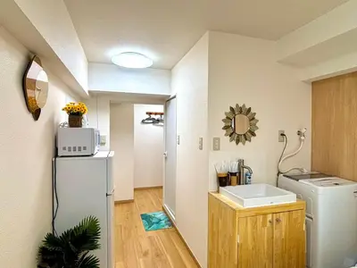 a small kitchen with a refrigerator and a sink at B2-Shinjuku center 3mins to ST Max 4P-\u65b0\u5bbf\u4e2d\u5fc3 \u5927\u4e45\u4fdd\u99c53\u5206\u949f \u8d85\u7ea7\u5546\u5708\u4ea4\u901a\u67a2\u7ebd \u6b65\u884c\u5230\u65b0\u5bbf\u6b4c\u821e\u4f0e\u753a \u5c71\u624b\u7dda\u76f4\u8fbe\u6e0b\u8c37\u9280\u5ea7\u6c60\u888b in Tokyo