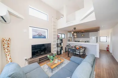 a living room with a blue couch and a table at Boasorte Urayasu in Tokyo