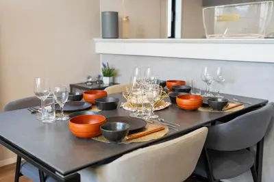 a table with wine glasses and plates on it at Boasorte Urayasu in Tokyo